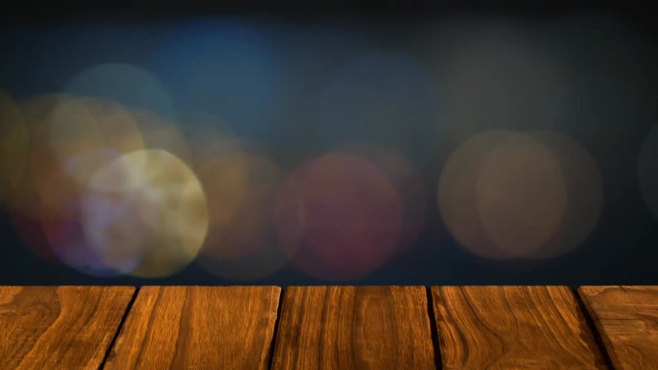 animación de múltiples manchas naranjas de luz parpadeando sobre tablas de madera