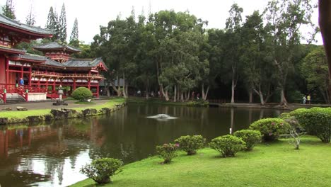 the byodo-in temple and the small pond in front, in the valley of the temples memorial park kahaluu, oahu, hawaii