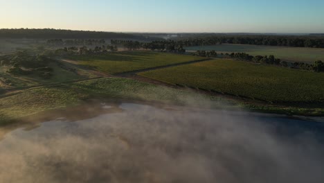 Drone-shot-of-flying-clouds-over-lake-in-countryside-of-Margaret-River,-Western-Australia