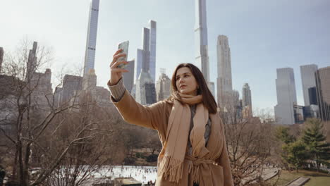 woman taking a selfie in central park, new york city