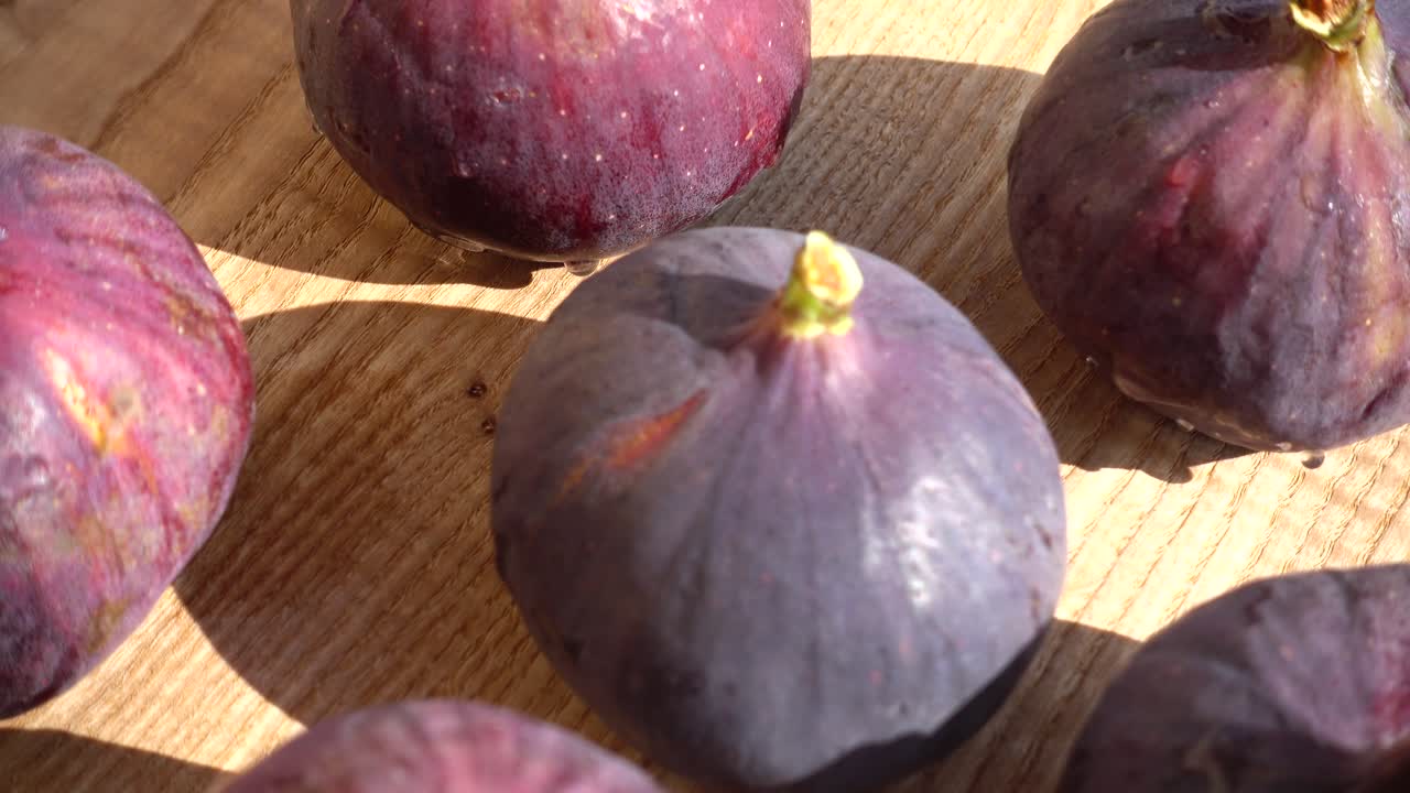 Close-up of Fresh Ripe Purple Figs on a Wooden Surface