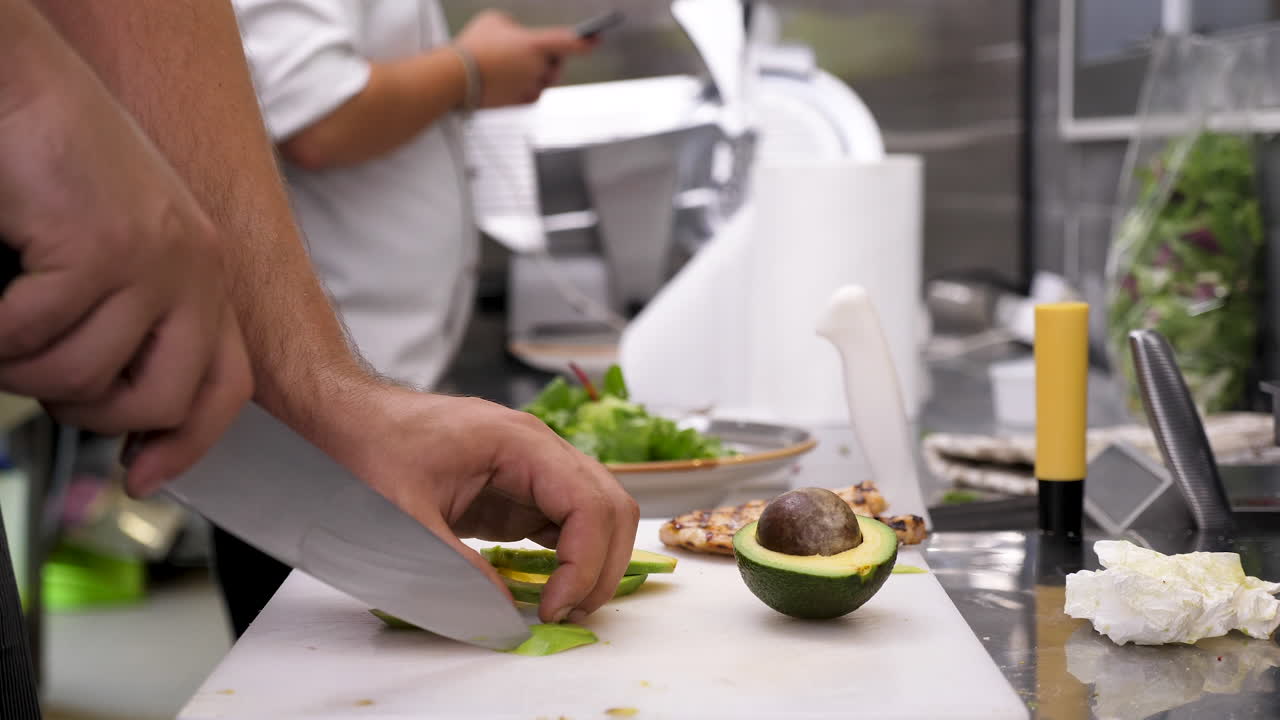 Chef preparing avocado in a restaurant kitchen