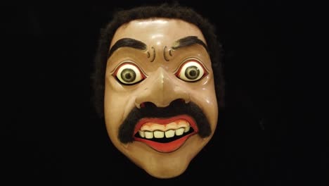 traditional topeng dance theatre wooden mask of bali indonesia closeup infinite black background