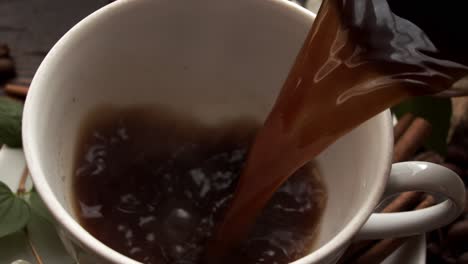 freshly brewed coffee being poured from cezve into cup