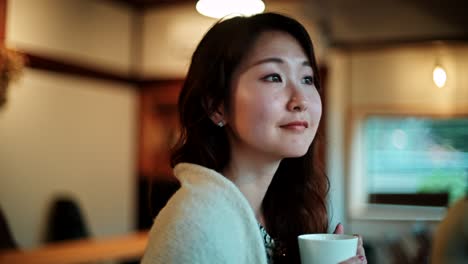 woman drinking coffee in a cozy cafe