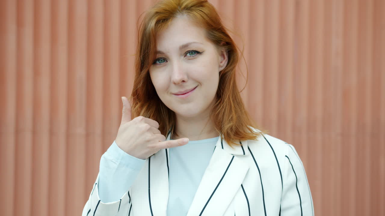 Woman Gesturing Call and Thumbs Up