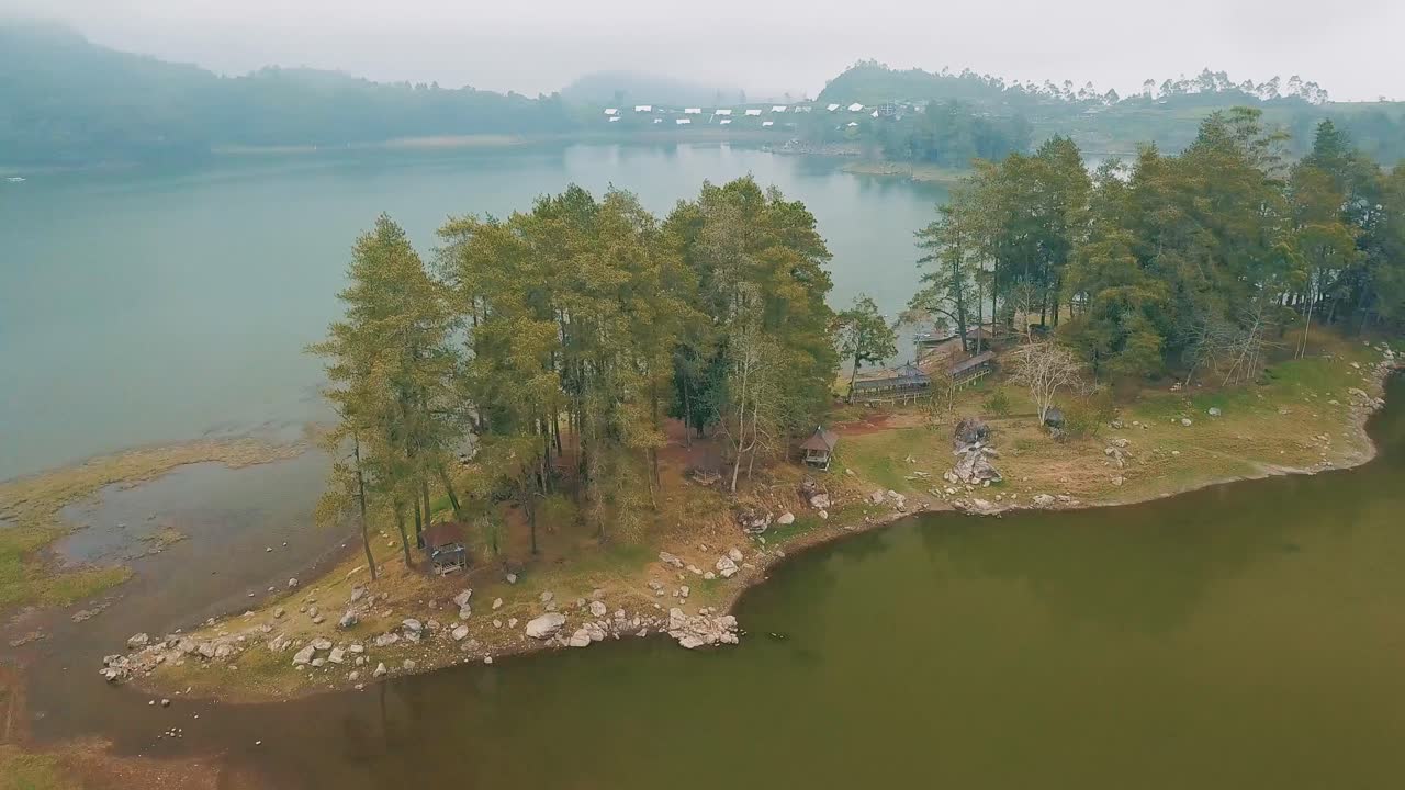 Lake with mountain and pine forest tea field