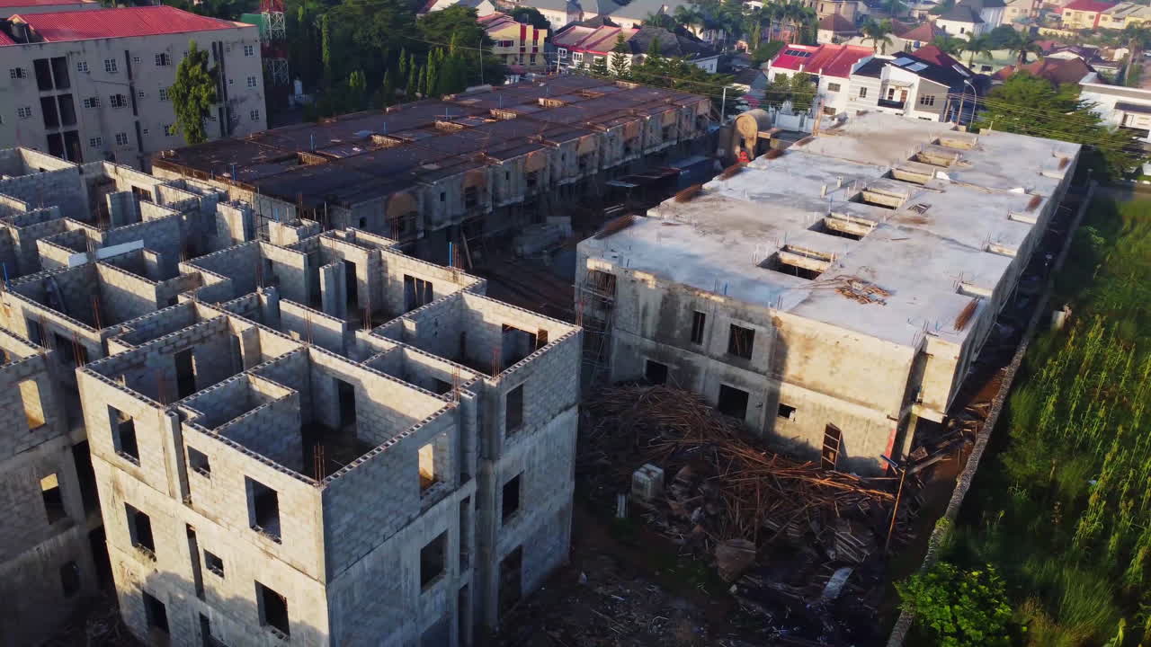 Beautiful aerial overview of large apartment buildings under construction in a new suburban neighborhood in Abuja, Nigeria, Africa on a sunny day