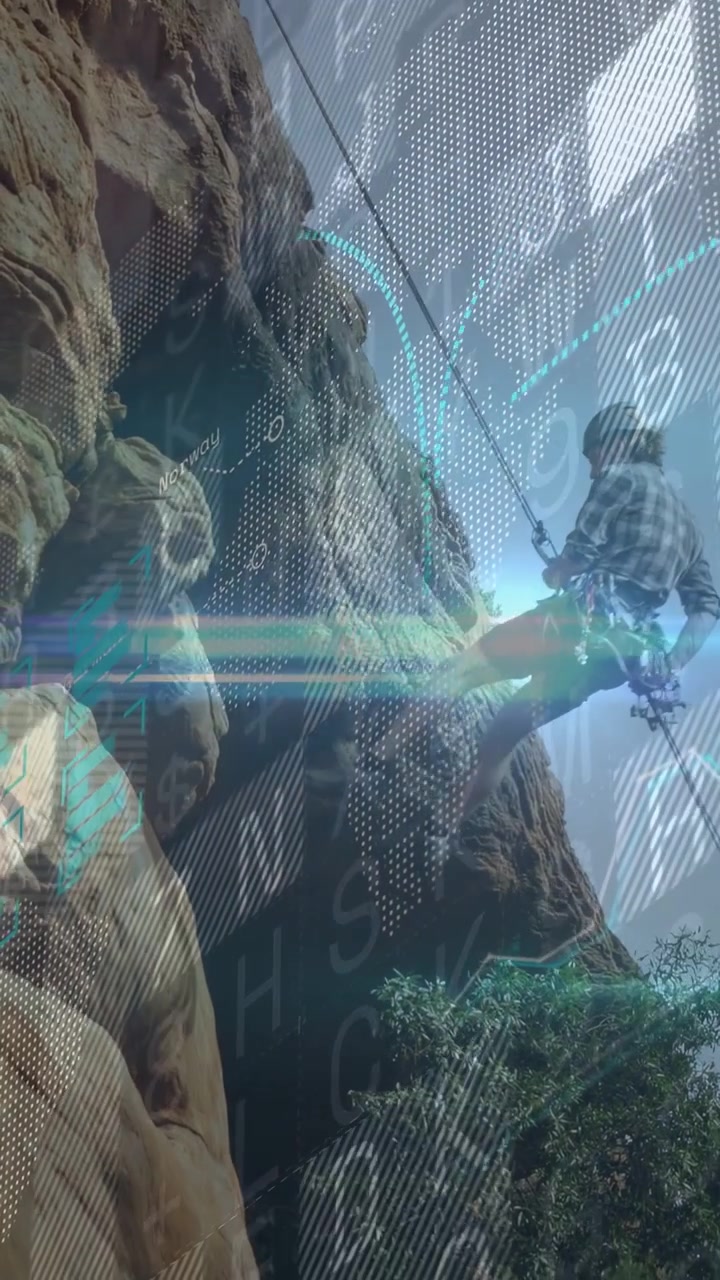 Vertical video: Cam panning showing male climber climbing cliff HUD overlaying map routing tech