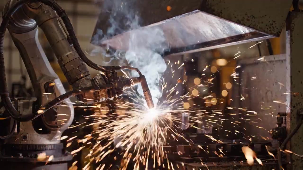 Automated Welding Process: Robotic Arm Welding with Sparks and Smoke in Industrial Setting, Showcasing the Precision of Modern Manufacturing Technology