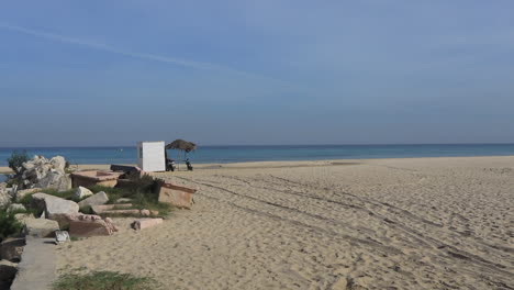 a peaceful beach scene with a small inlet and distant ocean view in an ancient arabic city