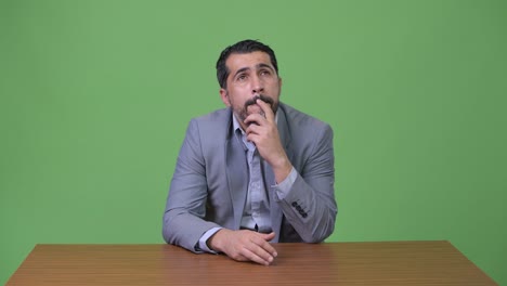 handsome persian bearded businessman thinking