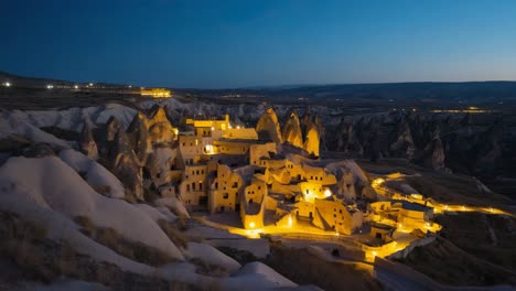 illuminated cave dwellings and rock formations in cappadocia at night