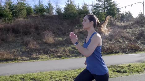 Fit-young-woman-running-in-Winter-slow-motion-tracking