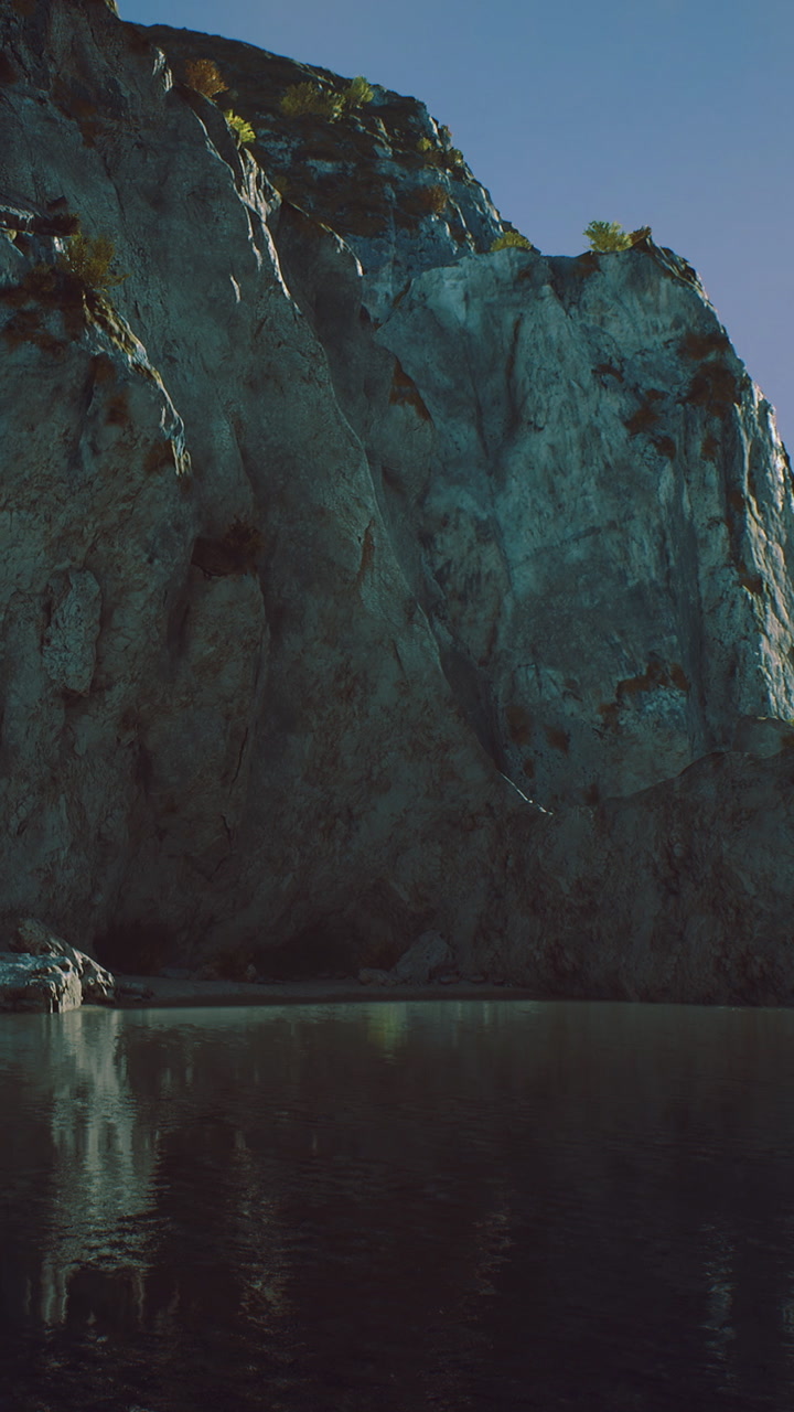 Majestic cliffs tower over serene waters at sunrise