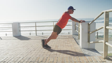 senior man performing stretching exercise on the promenade