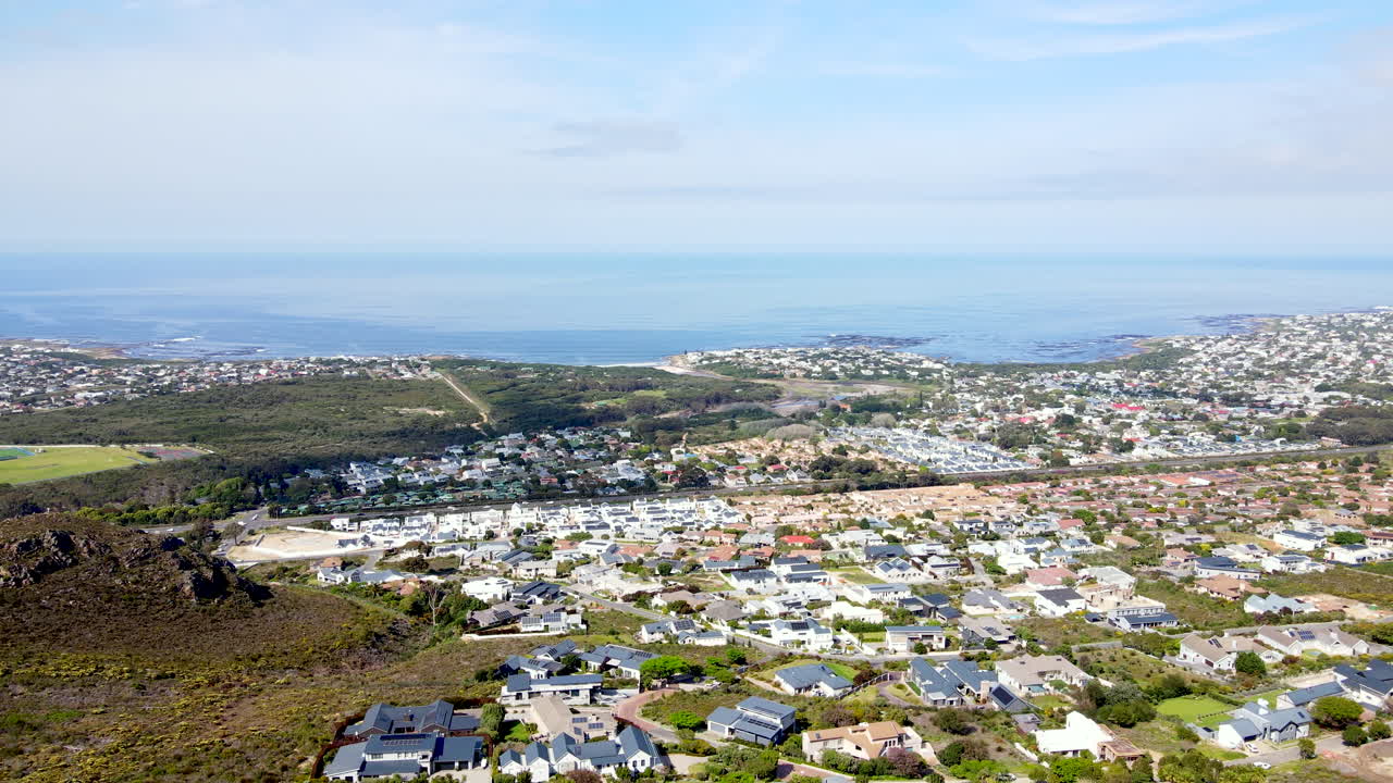 Aerial tilt-up over affluent Chanteclair neighborhood in Onrus with ocean views