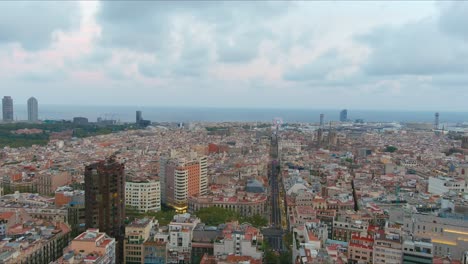 Barcelona-cityscape-with-sagrada-familia-and-cloudy-sky,-daytime,-aerial-view