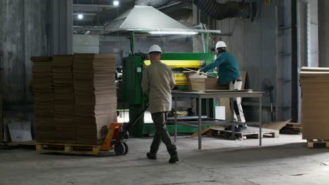 factory workers handling cardboard boxes