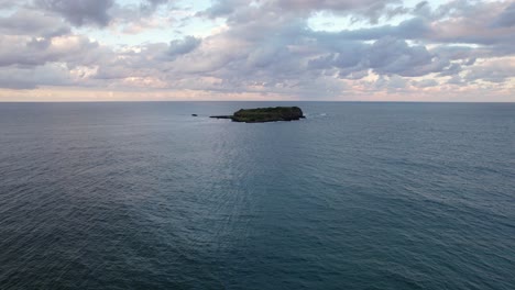 flying towards cook island nature reserve near fingal head in new south wales, australia