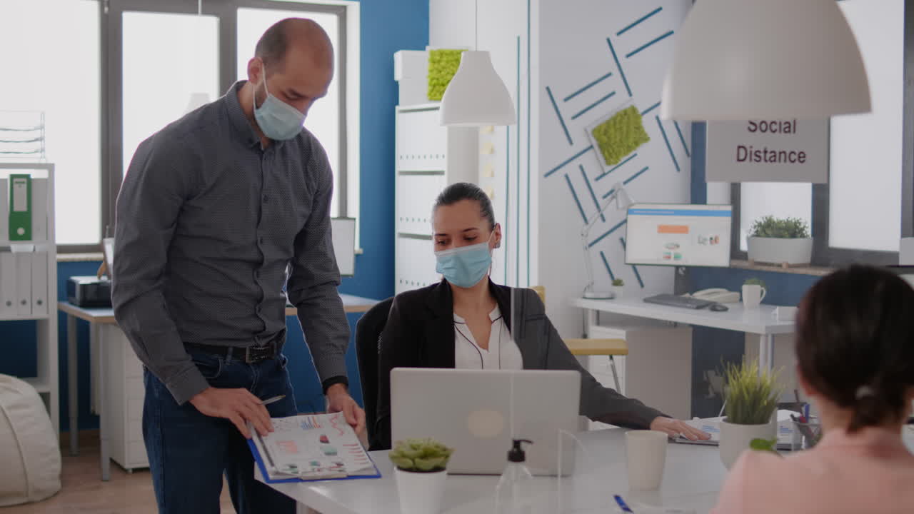 Bussines team with medical face mask working at marketing project