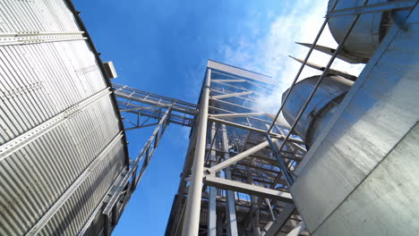 drying grain on a modern factory. large grain elevator and smoke from industry. vapor releases from industrial plant during grain processing.