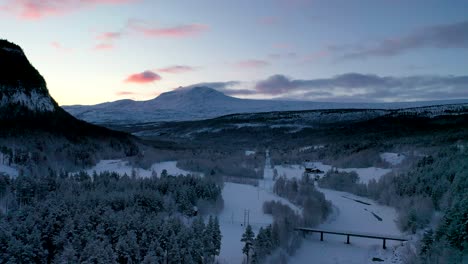 4k aerial views of norway’s arctic winter. features saltfjellet mountain, endless snow, and cinematic drone footage. with amazing golden hour light glowing in the sky.