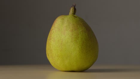 light shining and dimming on whole fresh pear