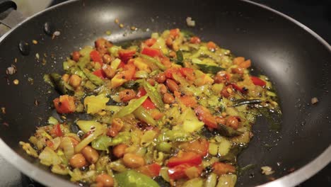 close up, frying veggies for food in a frying pan - concep of brain frying showing with vegetables