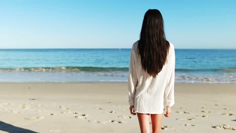 Woman-walking-on-beach