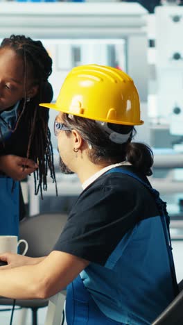 vertical video solar panels plant technician designing assembly lines, informing manager