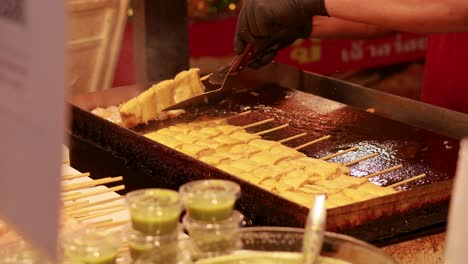 street food preparation at bangkok's floating market