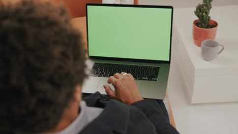 Young-black-man-is-working-from-home-on-laptop,-home-decoration,-living-room