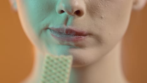 woman eating a piece of wafers, close up detail