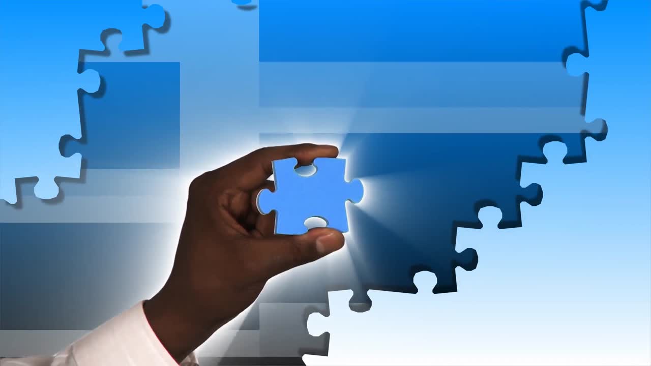 Hand holding a piece of puzzle