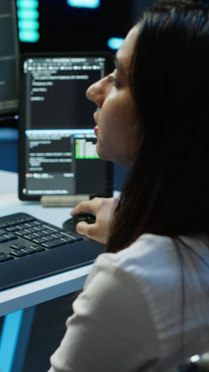 Female Programmer Typing Code on Keyboard in Dark Office