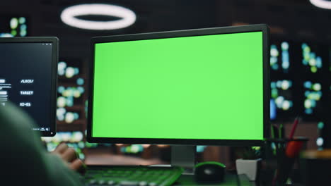 it specialist working greenscreen pc at datacenter closeup. man typing computer