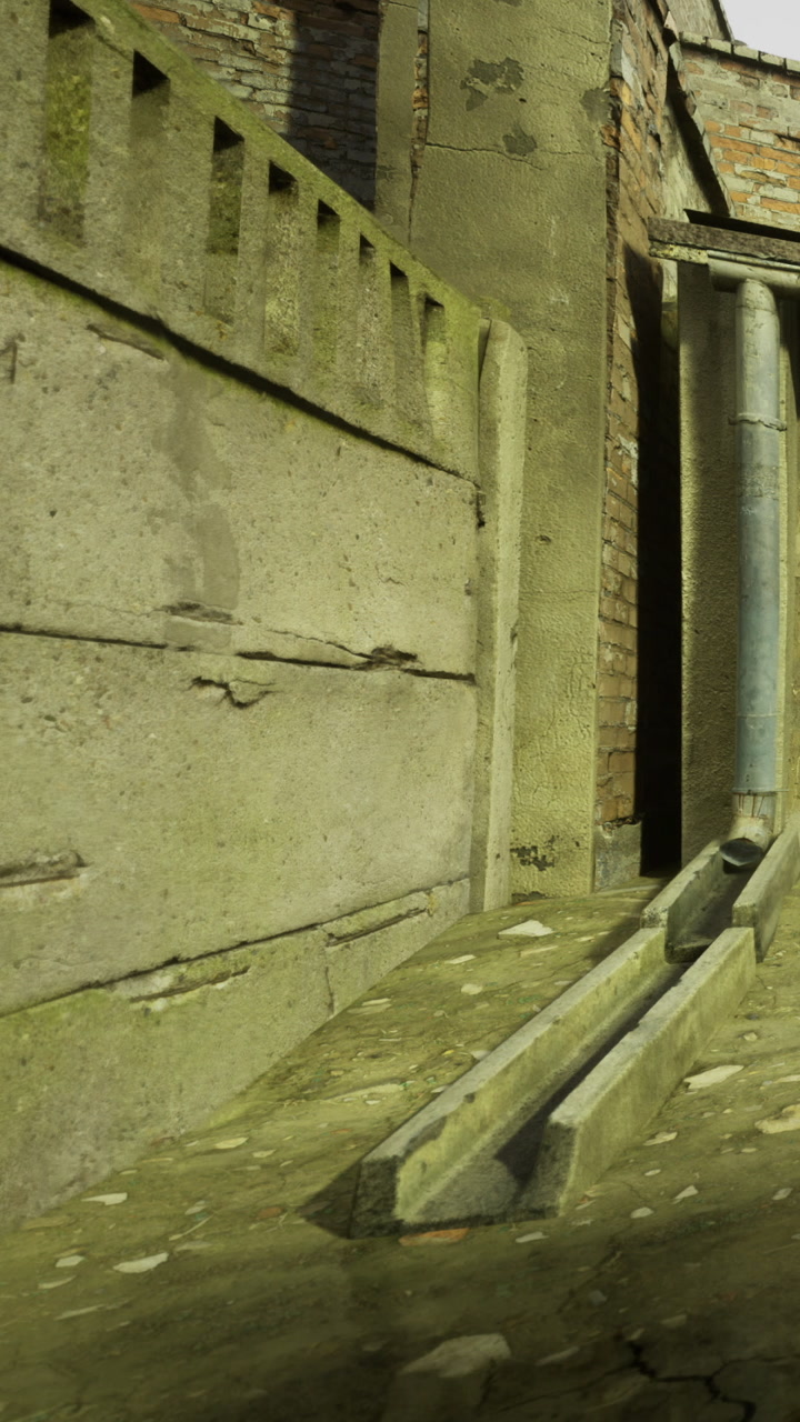 Pathway beside a building with worn concrete and brick walls near the entrance