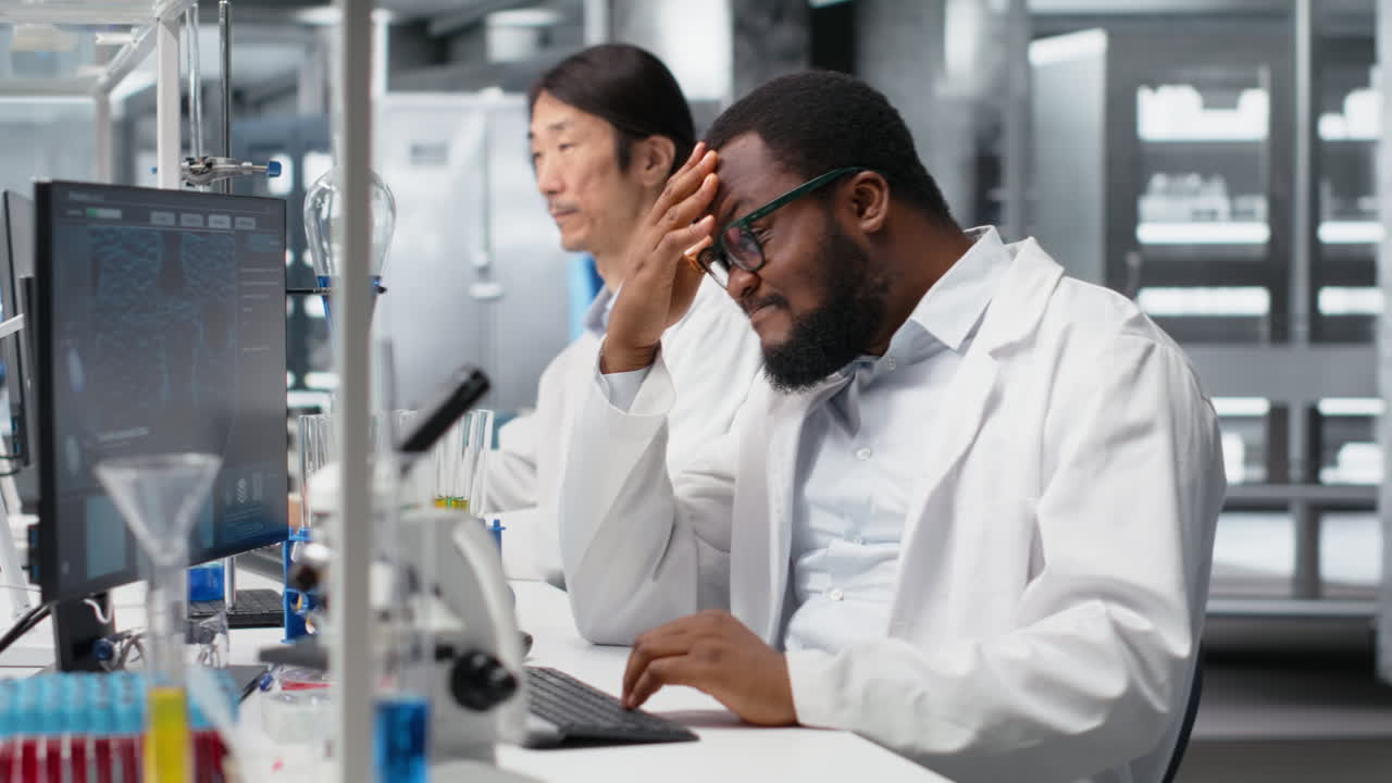 Vertical video Scientist uses computer for DNA data analysis in laboratory, doing brainstorming