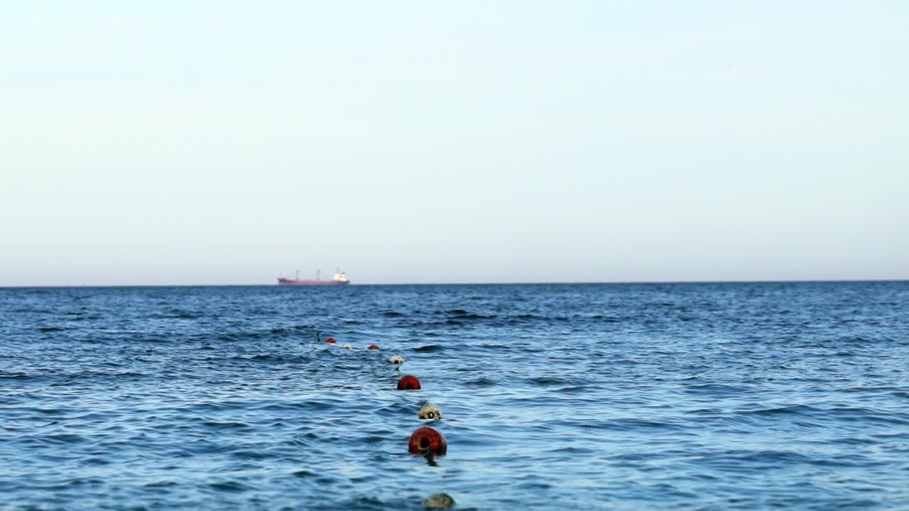 Floating buoy on blue sea. Lots of empty red mooring buoys floating on water