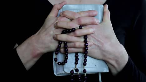 woman-praying-with-hand-over-her-face-on-grey-background-with-people-stock-video