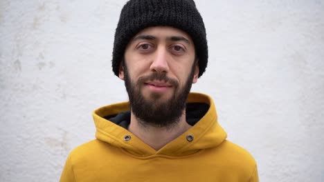 young caucasian man smiling with finger pointing to nose