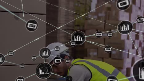 animation of network of connections with icons over caucasian man working in warehouse