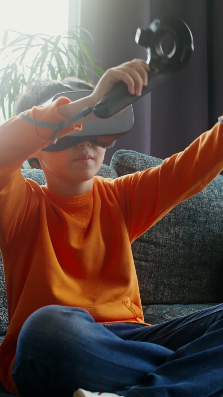 Boy wearing VR headset playing video game