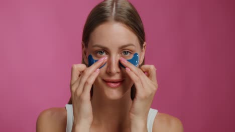 mujer aplicando parches en los ojos