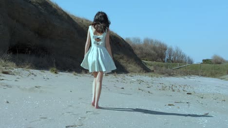 slow motion shot of pretty girl in white dress walk on the beach-1