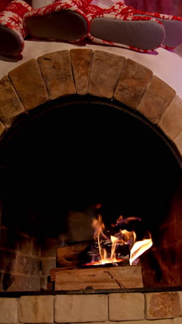fireplace interior at home in christmas time. beautiful fireplace in country house. background for the design of new year's greetings. warmth and comfort at home at winter holidays. vertical video