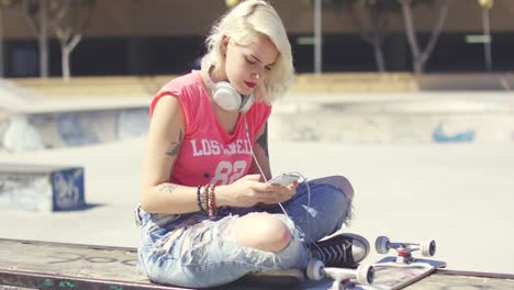 trendy young blond woman at a skate park