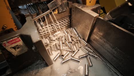 Cutting stainless steel pipes, the band saw for industrial cutting the metal stainless pipe and using the coolant heating. The industrial tool.
