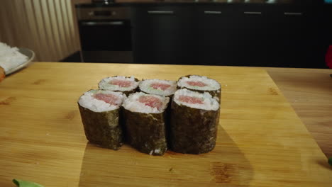 freshly prepared tuna sushi rolls on a wooden board
